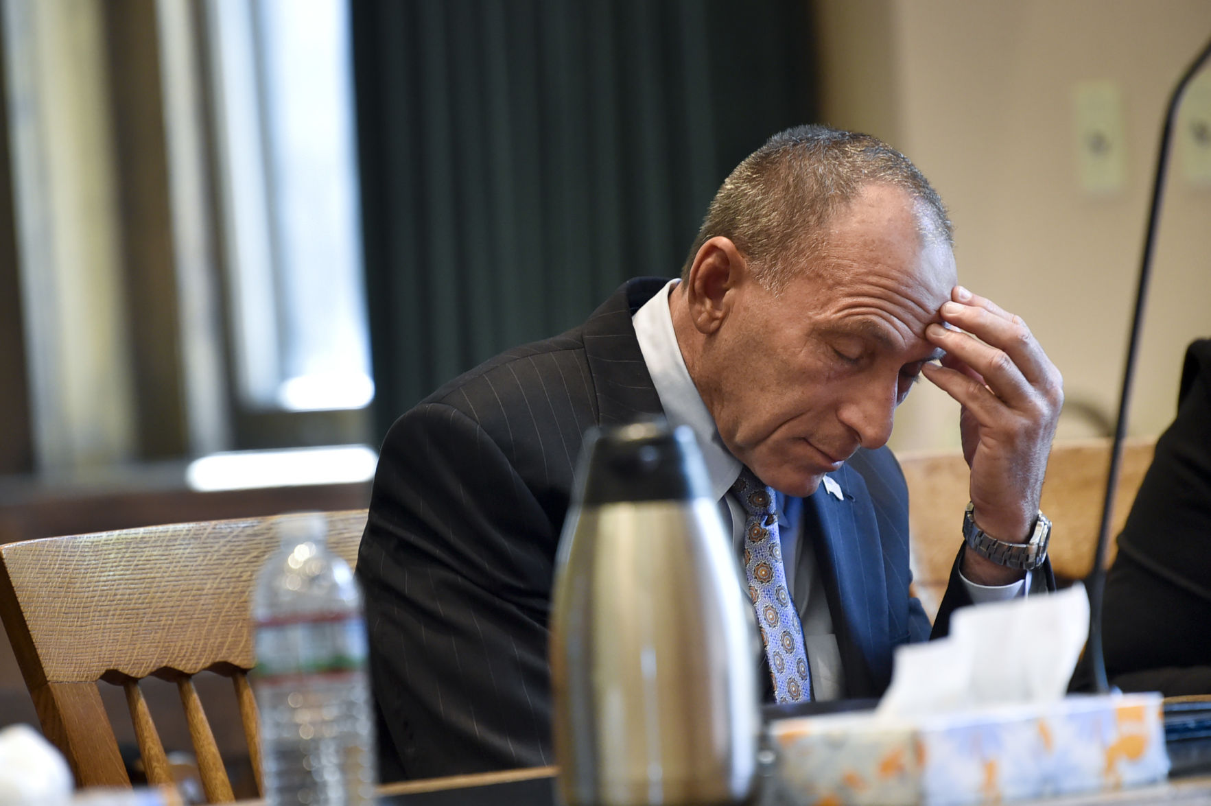 Gregg Trude puts his hand to his head before changing his plea to guilty